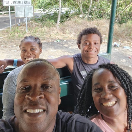 Family of four sits in cart and smiles for camera