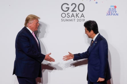 US President Donald Trump and Japan’s Prime Minister Shinzo Abe shake hands at the G20