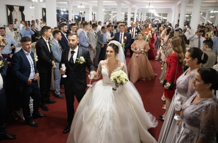Jesica Monica Bura and Grigore Pop-Hotcas arrive to their wedding party in the village wedding hall in Camarzana