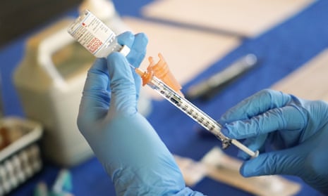A nurse prepares a syringe of a Covid-19 vaccine