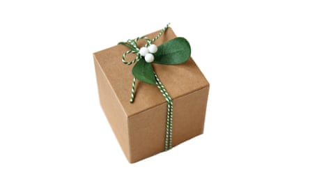 Paper Mistletoe on a gift wrapped in brown paper