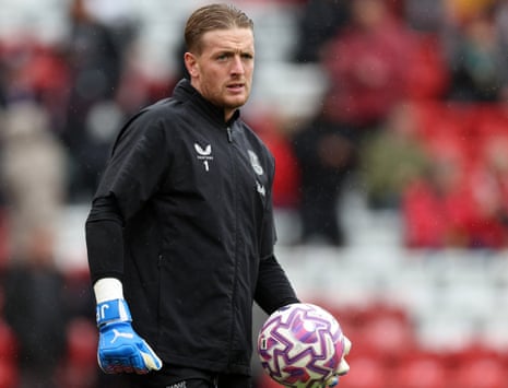 Everton goalkeeper Jordan Pickford warms up on a rainy afternoon at Anfield.