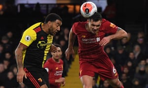 Troy Deeney of Watford (left) goes up for a header with Liverpool’s Dejan Lovren.