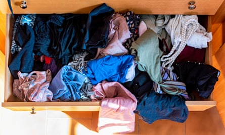 Open drawer with messy clothes inside