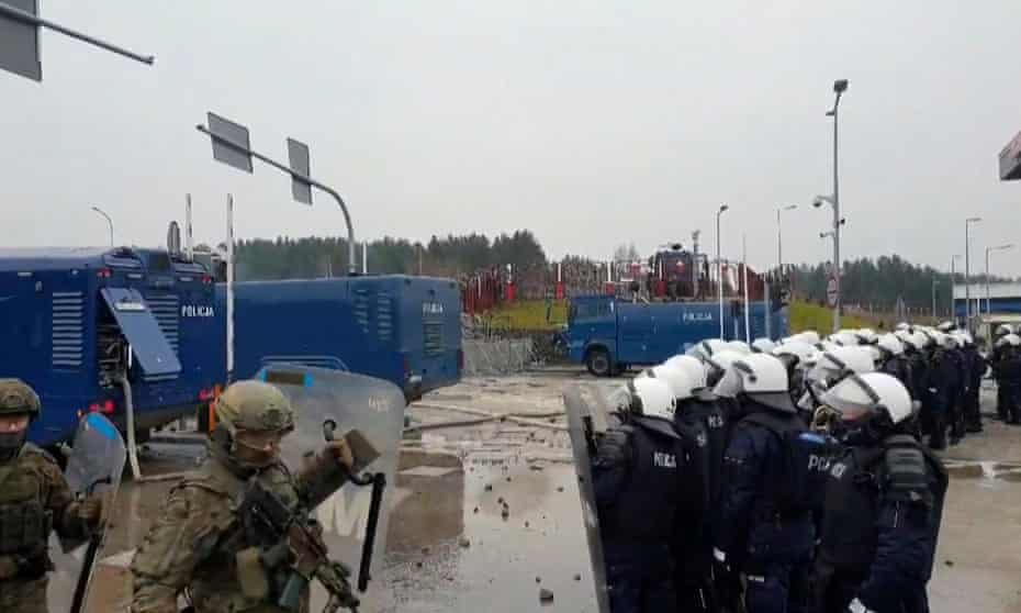 A video grab shows Polish forces after people camped at the Belarus border threw stones at them.