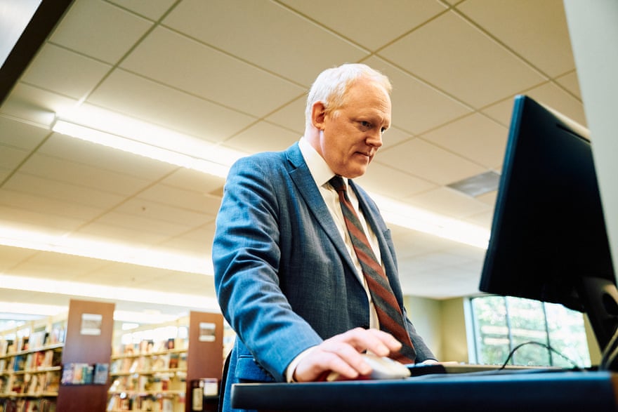 Jason Kuhl stands in front of a computer at the St. Charles City, Missouri County Library.