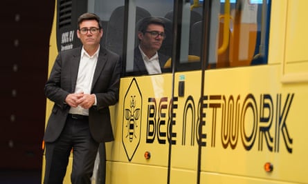 Greater Manchester mayor, Andy Burnham, next to a Bee Network bus.