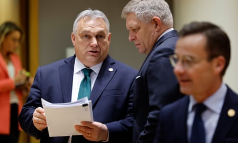 Orbán (left) talking to Slovakia's prime minister, Robert Fico, during a roundtable meeting in Brussels.