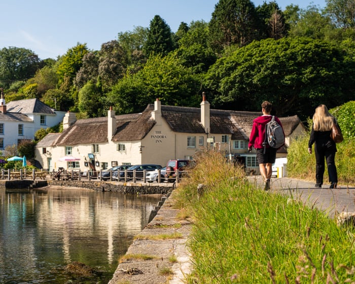 ‘Sipping a pint while trout splashed in the river on a perfect summer’s day’: readers’ favourite UK waterside pubs