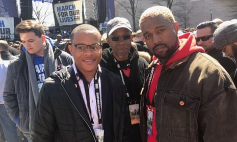 Speaker and gun reform activist Zion Kelly, whose twin brother was shot dead last year, pictured with pop star Kanye West at the march in Washington