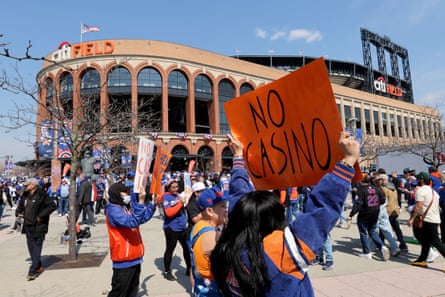 A group of people hold signs that say ‘No casino’