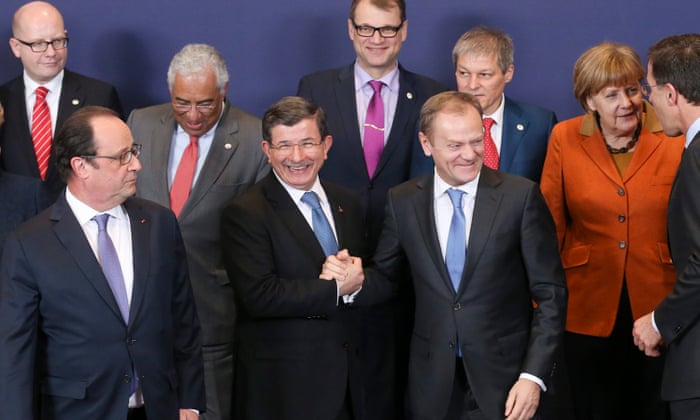 European Council President Donald Tusk (C-R) greets Turkish Prime Minister Ahmet Davutoglu
