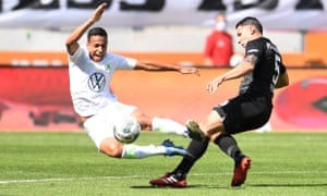 Augsburg’ s Marek Suchy feels the force of a tackle from Wolfsburg’s João Victor.