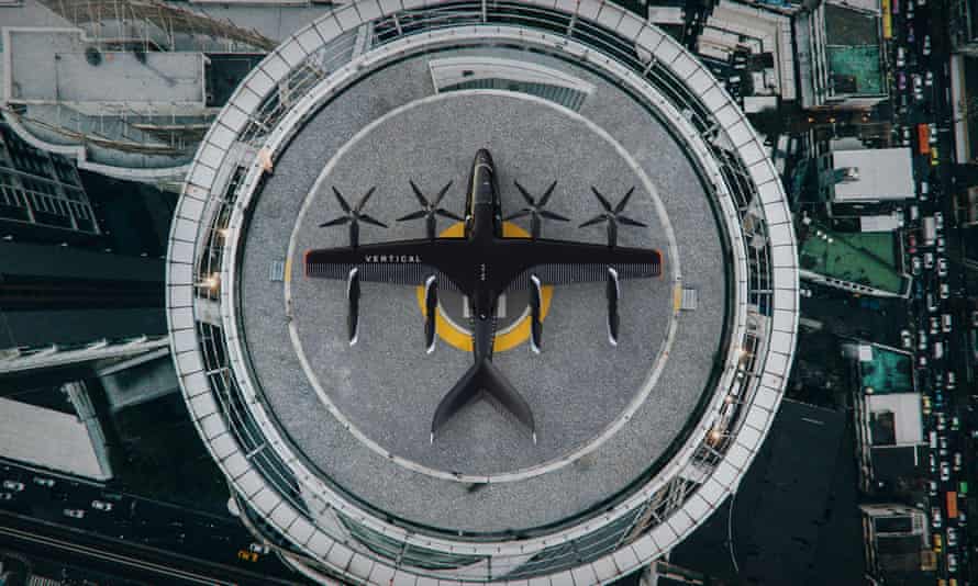Realistic illustration of a small, black, winged four-rotor aircraft on a circular landing pad, seen from a height, directly above