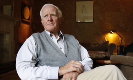 john le carre sitting with legs crossed