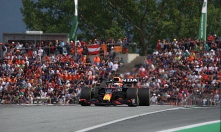 Max Verstappen drives past orange-clad supporters in the stands at the Red Bull Ring