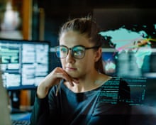 a woman sitting at a desk with her hand on her chin a woman sitting at a desk with her hand on her chin