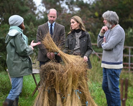 Prince and Princess of Wales stand by some flax while Helen Keys to their right speaks to them and Charlie Mallon to their left looks on.