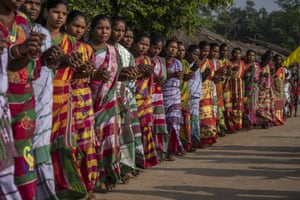 Guduta, India. Women perform an indigenous folk dance as they follow worshippers to a sacred grove believed to be the home of the village goddess