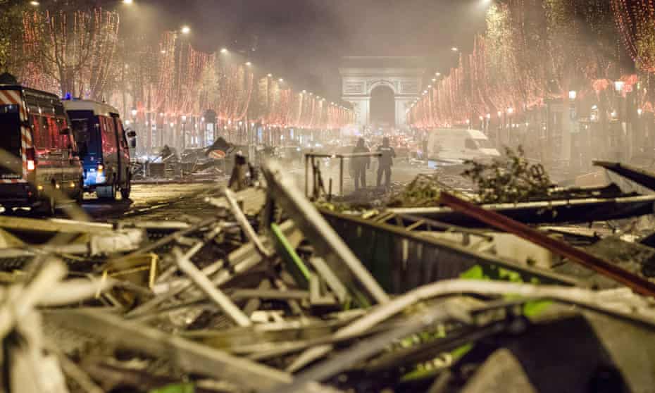 Cleaning crews clear the debris and barricades on the Champs-Élysées after the protests.