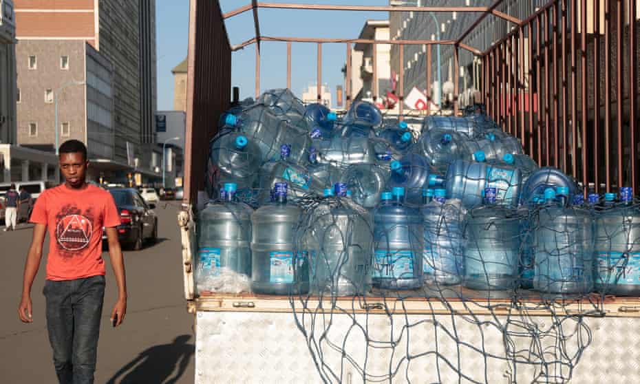 A truck carrying bottled water in Harare, Zimbabwe
