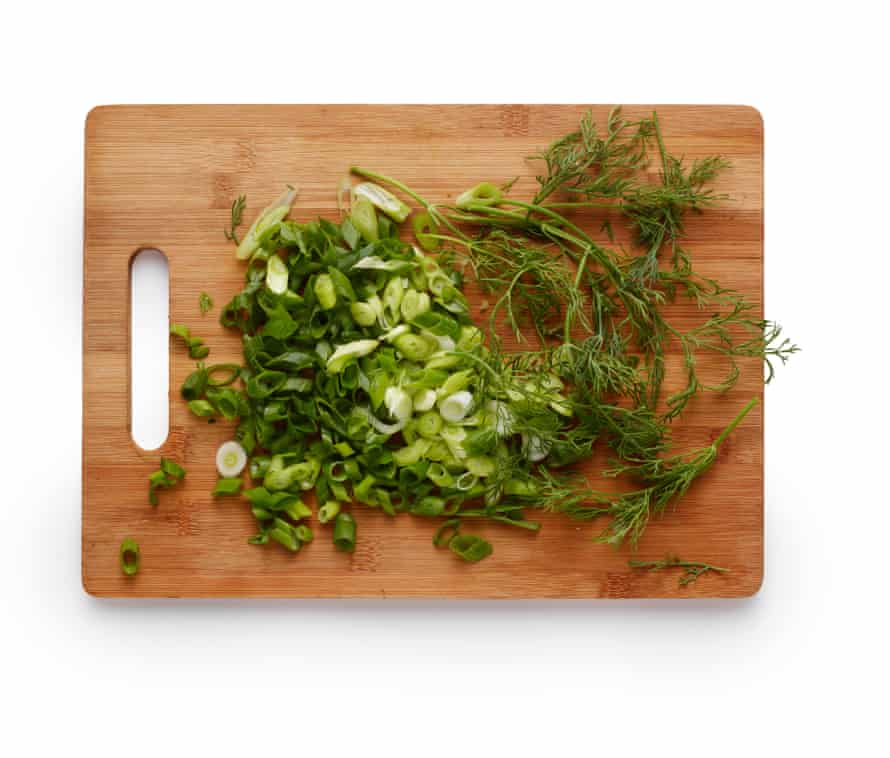 Felicity Cloake’s courgette fritters 4: adding egg, spring onions, herbs.