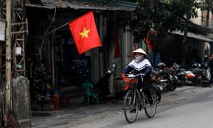 A street vendor rides a bicycle along a street in Hanoi, Vietnam, 05 January 2021.