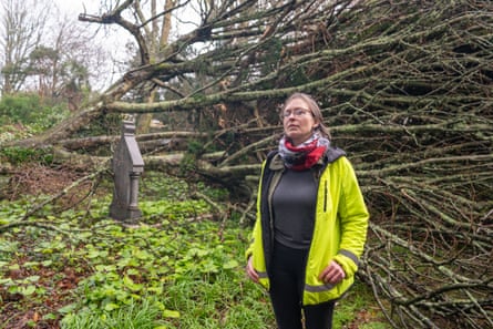 Juliet Line standing in front of a tree blown down in a storm