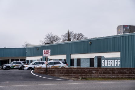exterior of blue building with police cars