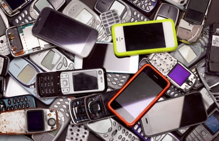 A pile of discarded mobile phones and smartphones.