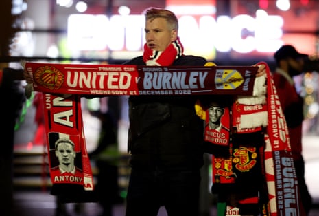 General view of a man selling merchandise outside the stadium before the match.