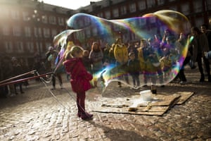 Madrid, Spain A child stands inside a large soap bubble