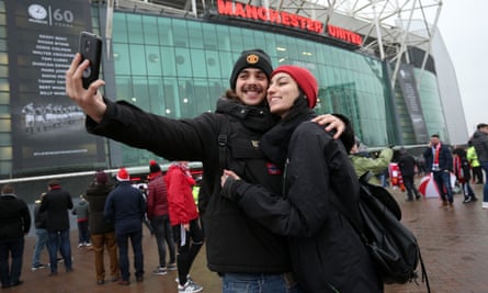Couple taking selfie outside of Old Trafford