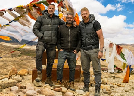 Paddy McGuinness, Chris Harris and Andrew ‘Freddie’ Flintoff standing outside in a row on some rocks in a desert-like setting