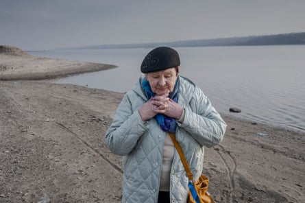 Valentina Vynychenko stands by the Dnipro River in Zaporizhzhia.