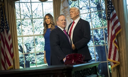 Sean Spicer in front of waxworks of Melania and Donald Trump at Madame Tussauds