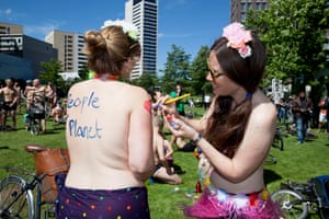 Participants apply body paint before the beginning of the London World Naked Bike Ride in Kings Cross