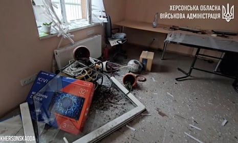 View of a blown-out window frame and damaged equipment inside an office after a reported deadly Russian artillery strike in Kherson.