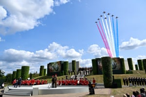 Red, white and blue vapours trail behind jets as they pass over the National Memorial Arboretum as members of the armed forces and the public take part in a remembrance service
