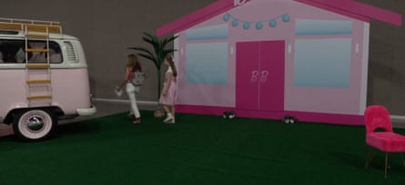 A plastic two-dimensional picture of a pink house on some fake grass