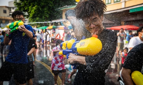 Festivalgoers spray water at each other during Songkran in Bangkok