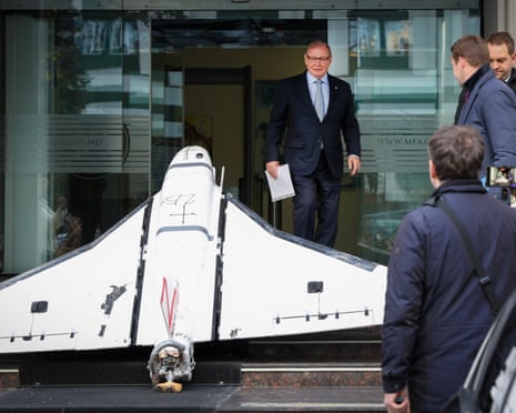 Oleg Ozerov (C), Ambassador of the Russian Federation to Chisinau, looks at a Russian-made Gerbera drone recovered by the Moldovan police.