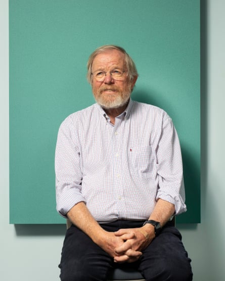 A man with glasses poses in a recording studio