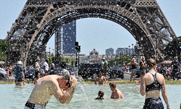 People cool off in the Trocadéro fountains, near the Eiffel Tower, during a heatwave in France on 29 June 2019.