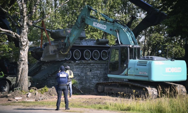 Workers remove a Soviet T-34 tank installed as a monument in Narva, Estonia.