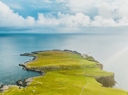 A grassy headland surrounded by ocean.