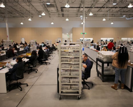 Election workers process ballots during the California primary election in City of Industry, California.