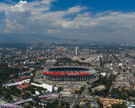 An aerial view of the stadium, with the Mexico City skyline in the background.