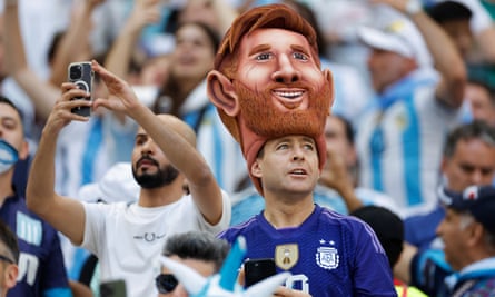 Argentina fans, with one wearing a giant Messi hat on their head