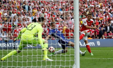 Arsenal’s Mesut Ozil shoots against the post.